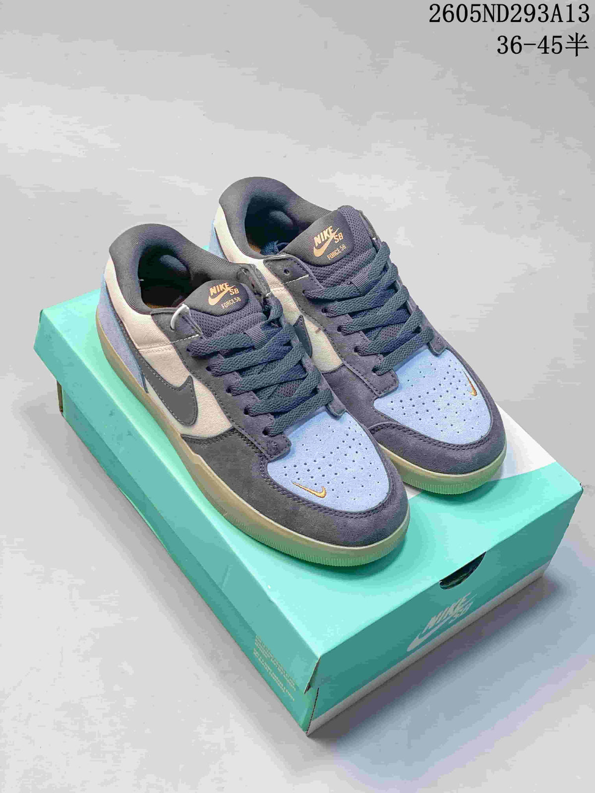 Pair of blue, gray, and off-white Nike SB Force 58 low-top shoes on a turquoise box