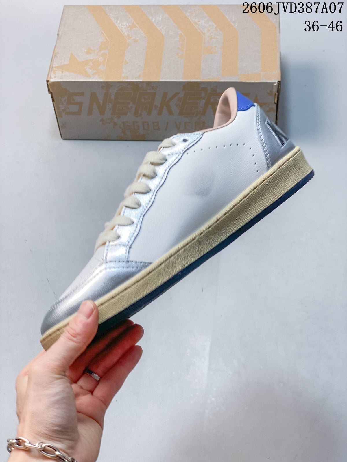 Side profile showing the white upper, silver panels, and cream-colored sole