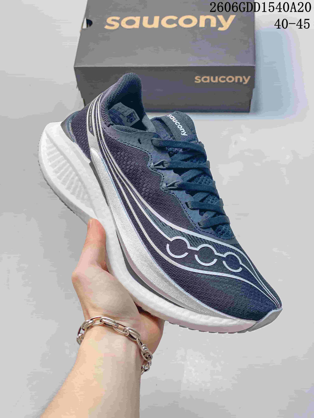 Side view of a dark navy Saucony running shoe with a white midsole.