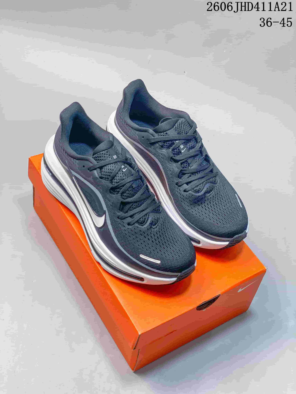 Pair of dark gray Nike Air Zoom Winflo 12 running shoes on an orange shoebox; image labels show 36–45.