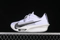 Side view of a white Nike running shoe with a large black Swoosh and sculpted sole