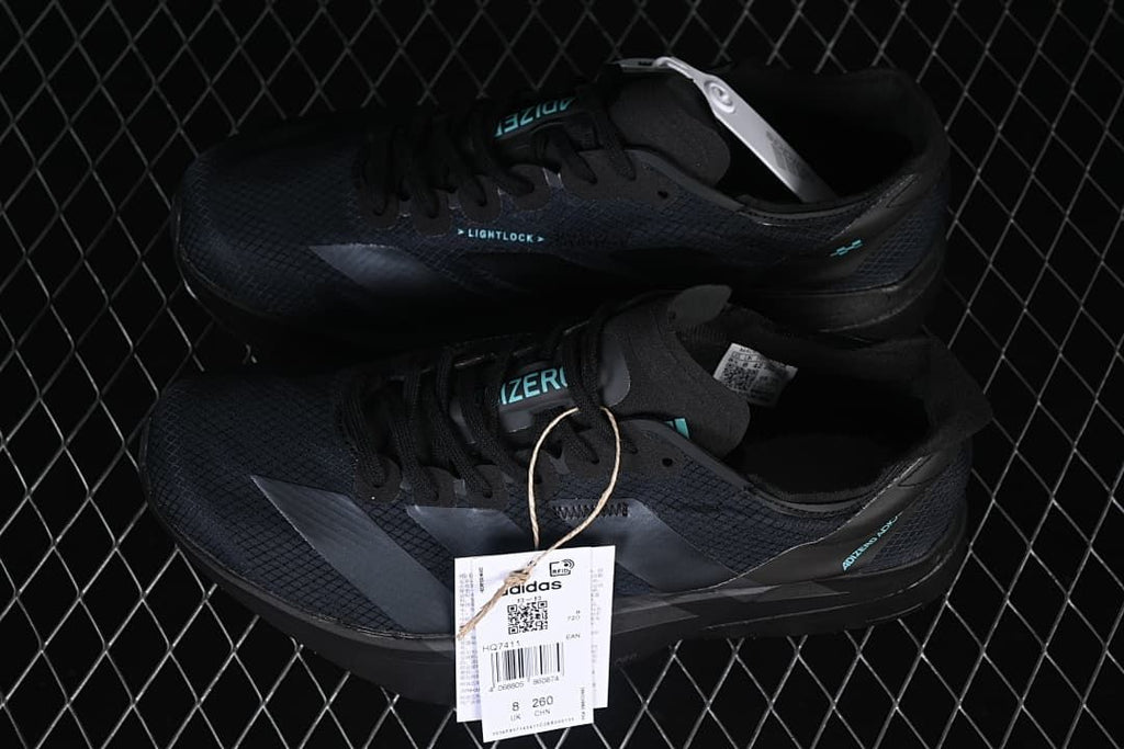 Pair of black running shoes with product hangtags