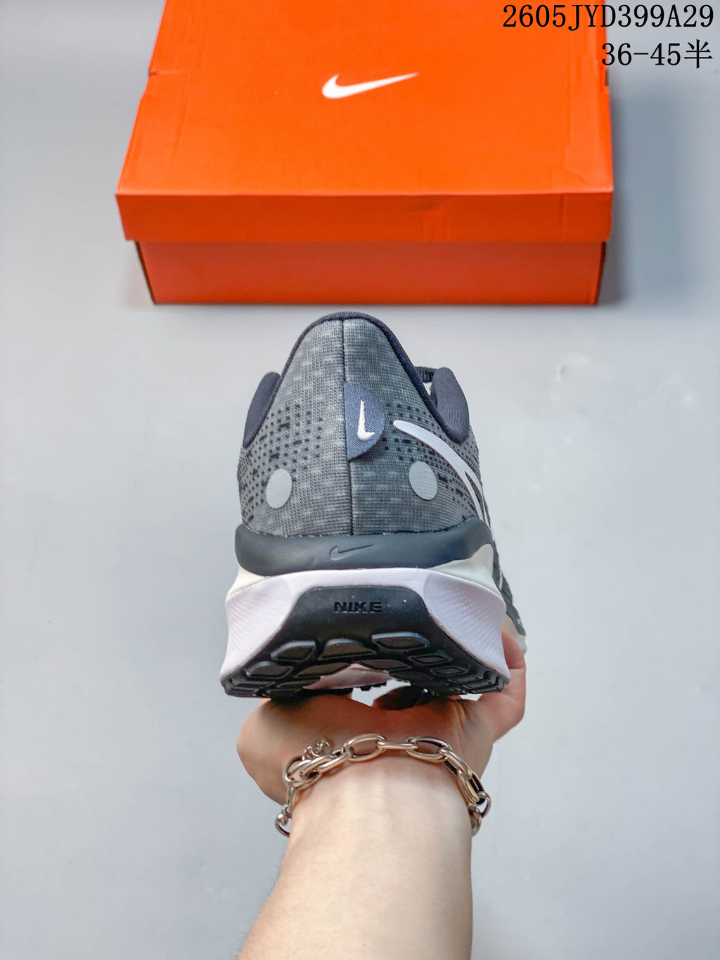 Rear view of the grey running shoe with white midsole
