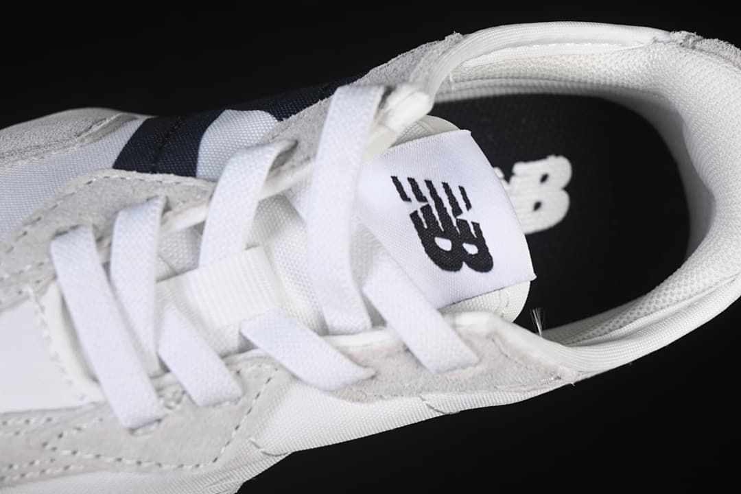 Top close-up of the laces, tongue logo, and collar.