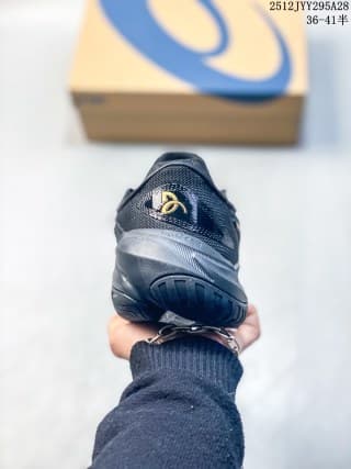 Rear view of the dark navy ASICS sneaker showing the heel construction and outsole pattern.