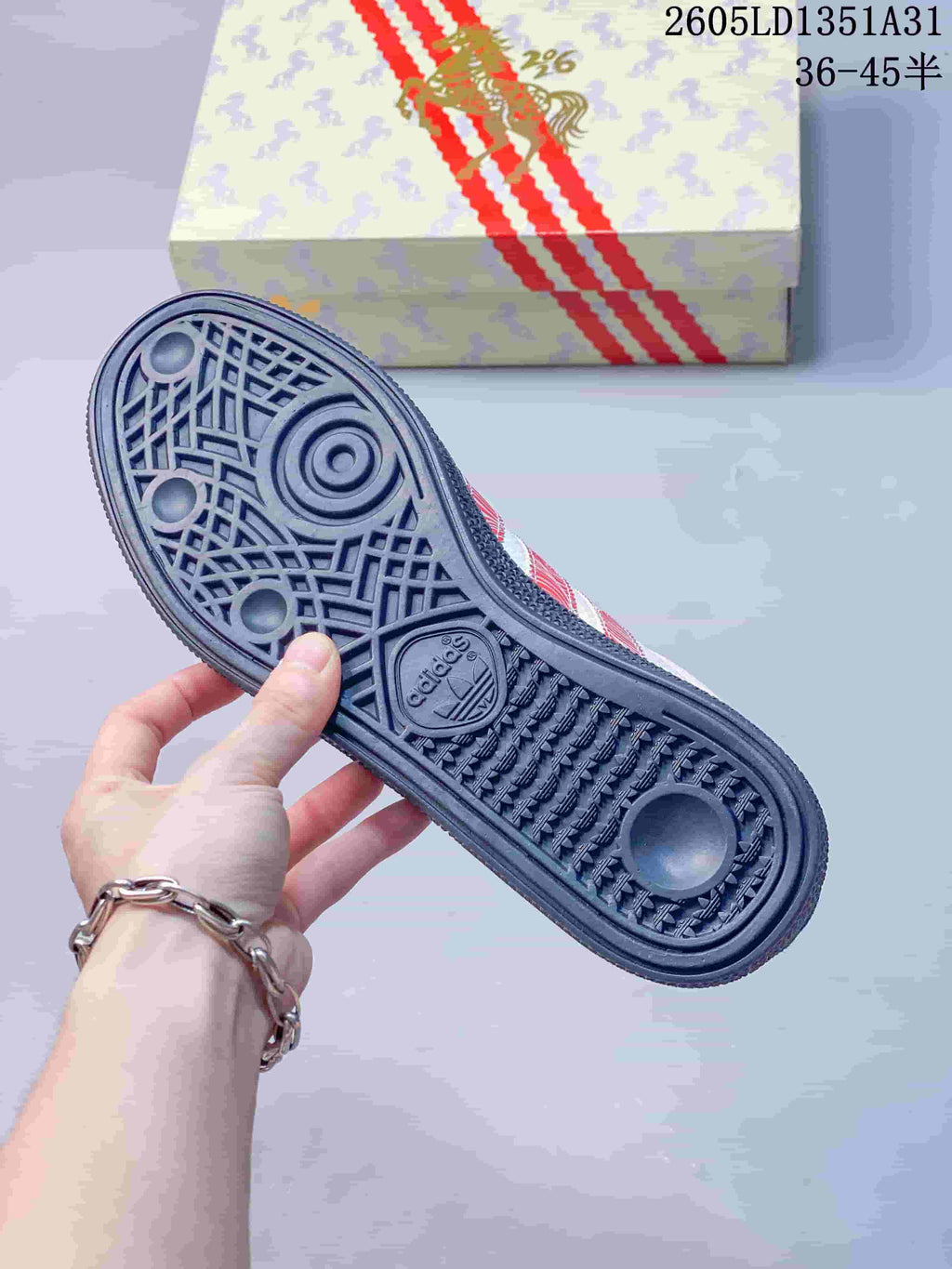 Close-up of the dark patterned outsole and decorated shoe box