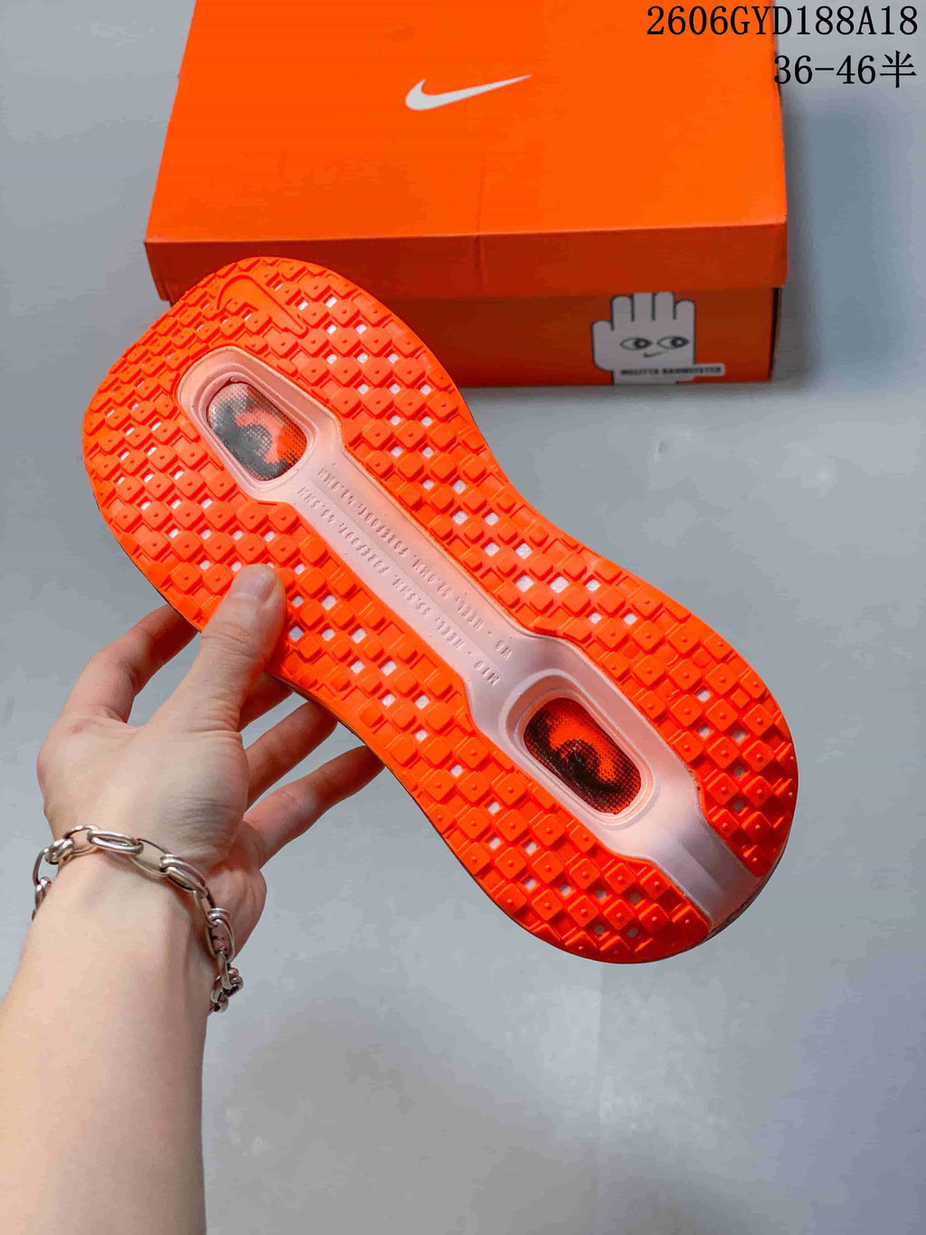 Orange outsole of a Nike Air Pegasus Premium sneaker with patterned tread and visible cushioning windows.