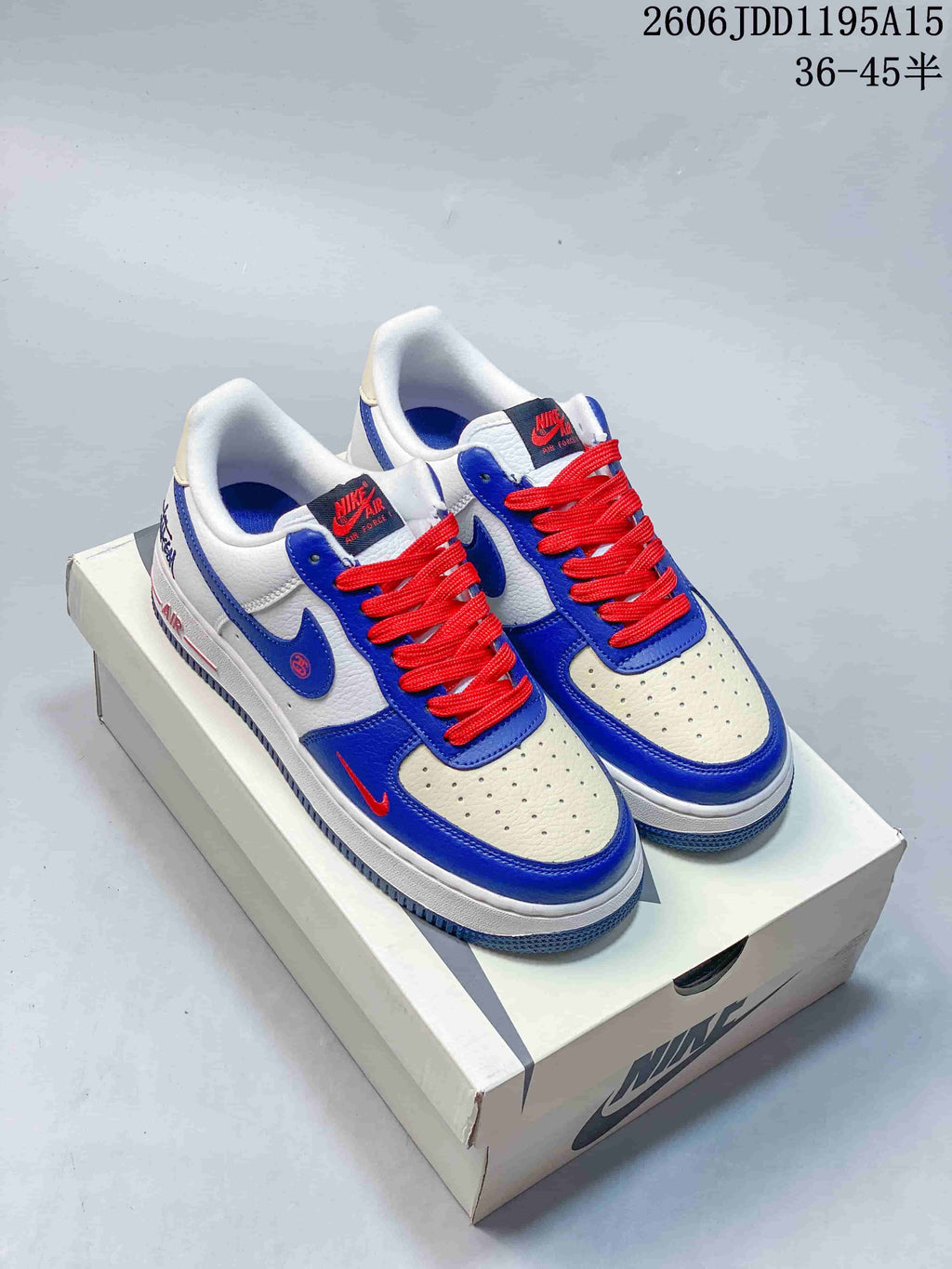 Pair of white, blue and red Nike Air Force 1 Low sneakers on a shoe box