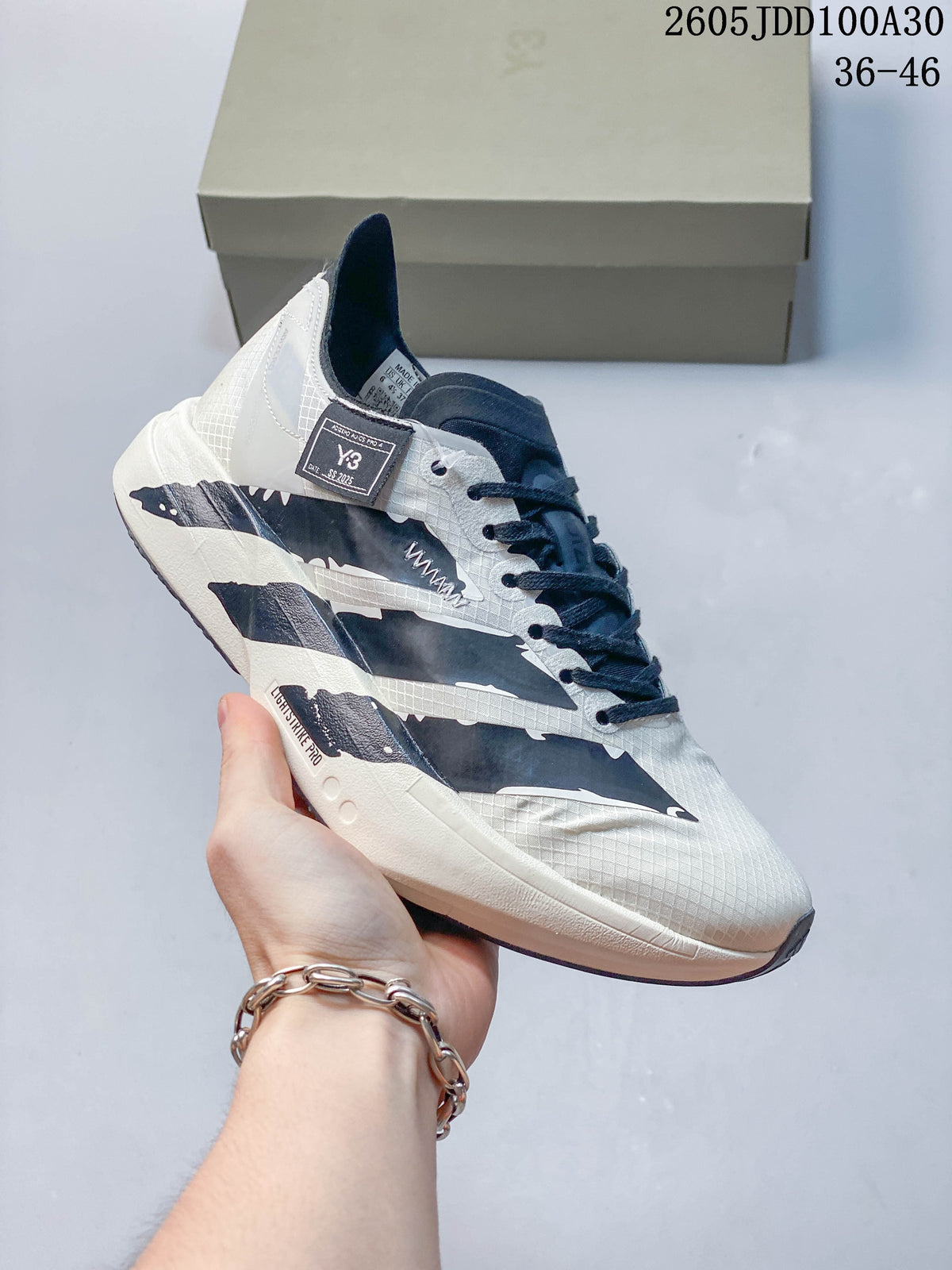 Side view of the running shoe with dark laces and graphic accents