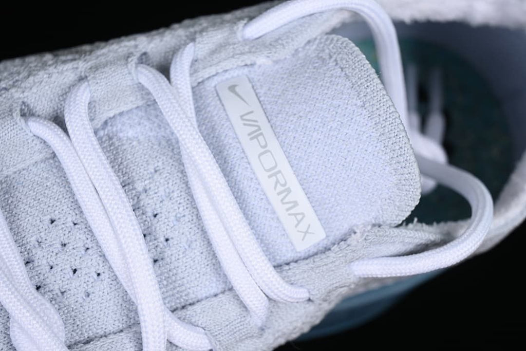 Close-up of the VaporMax tongue label and white laces