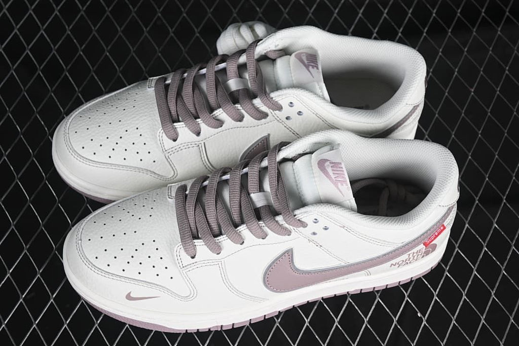 Pair of white and mauve low-top sneakers viewed from above