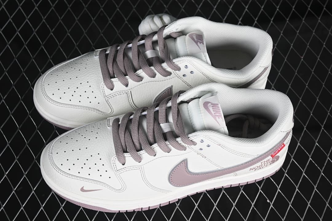 Pair of white and mauve low-top sneakers viewed from above