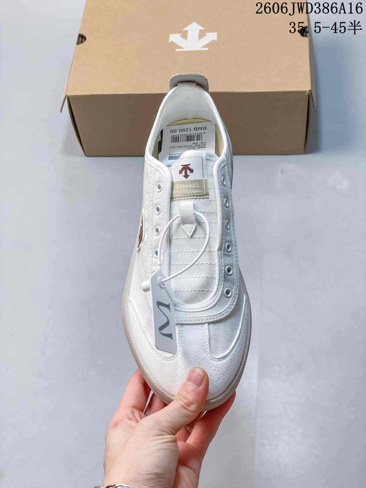 Top view of the white sneaker showing its T-toe, eyelet panel, and tongue label