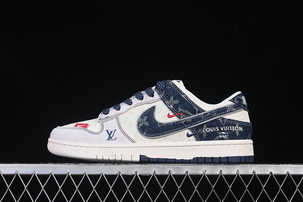 Side view of an off-white and navy Nike SB Dunk Low-style sneaker with denim-style panels and patterned detailing.