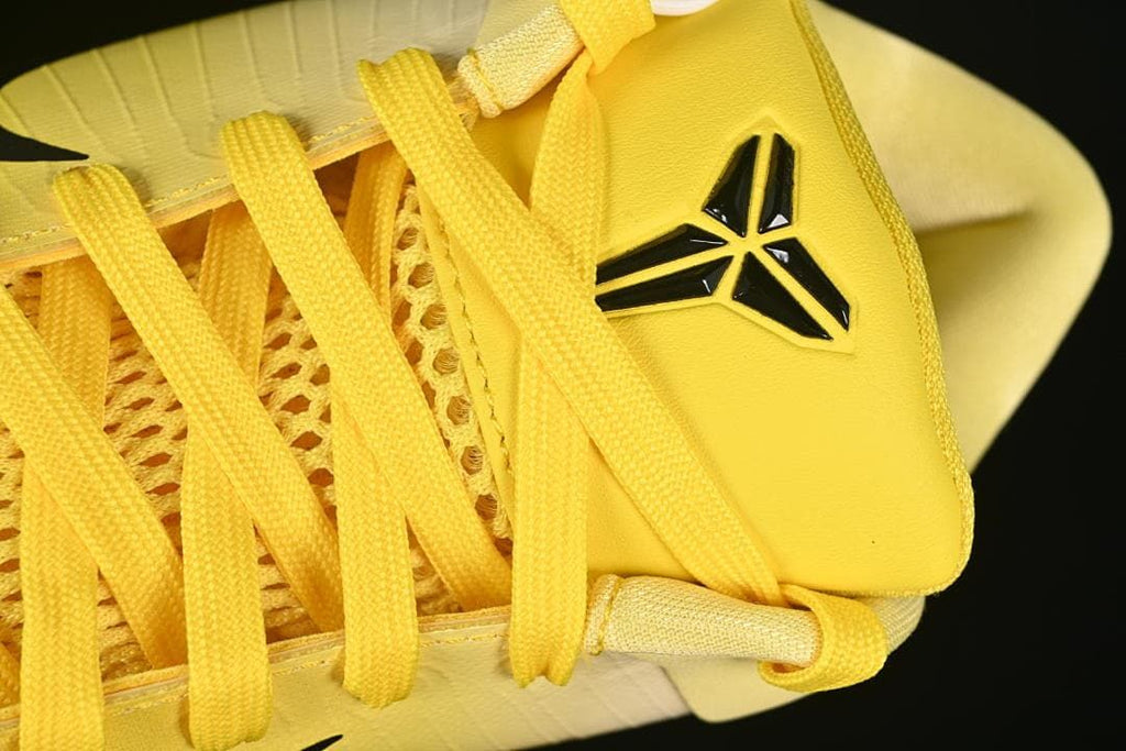 Close-up of tongue logo and yellow laces