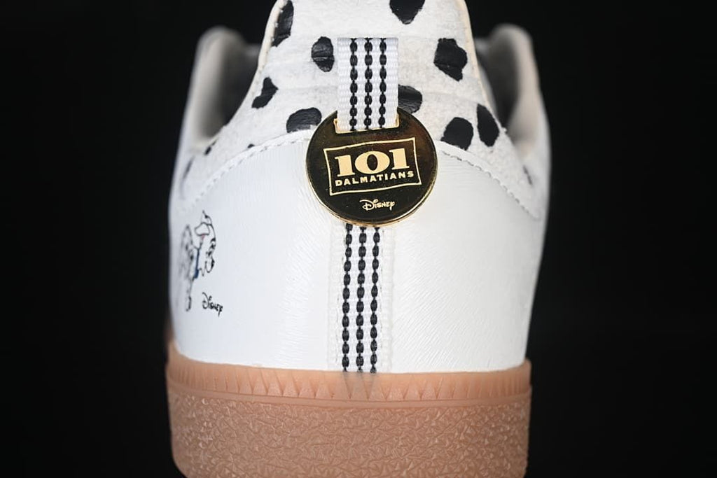 Rear view showing spotted heel panels, character artwork, and a round gold-tone charm.