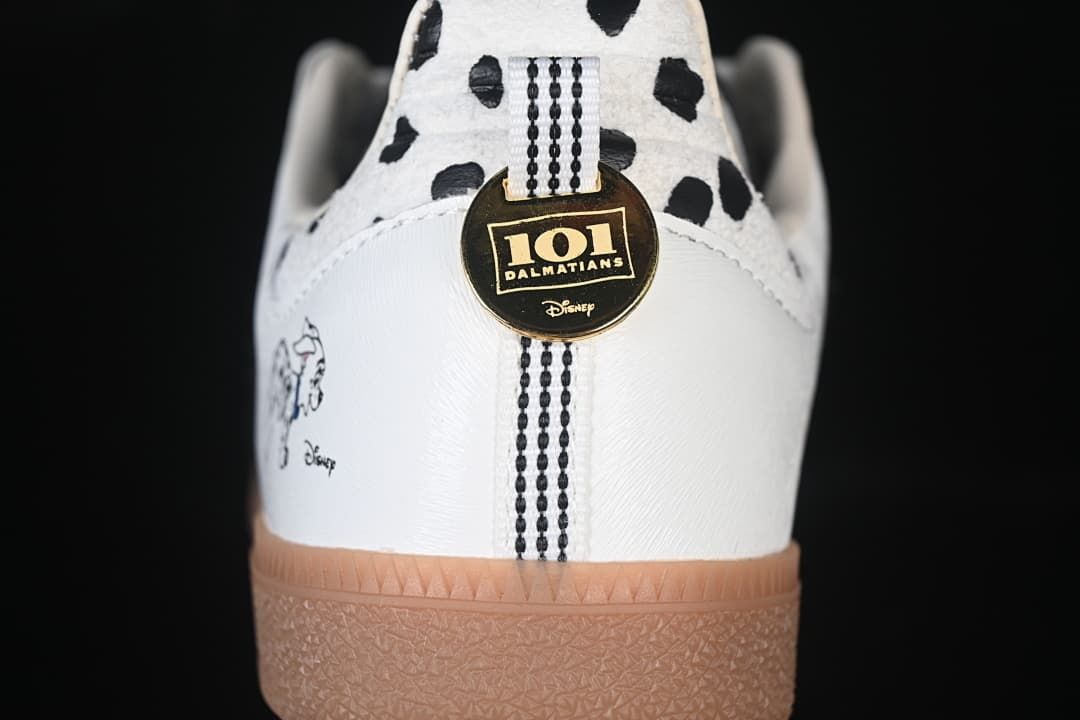 Rear view showing spotted heel panels, character artwork, and a round gold-tone charm.