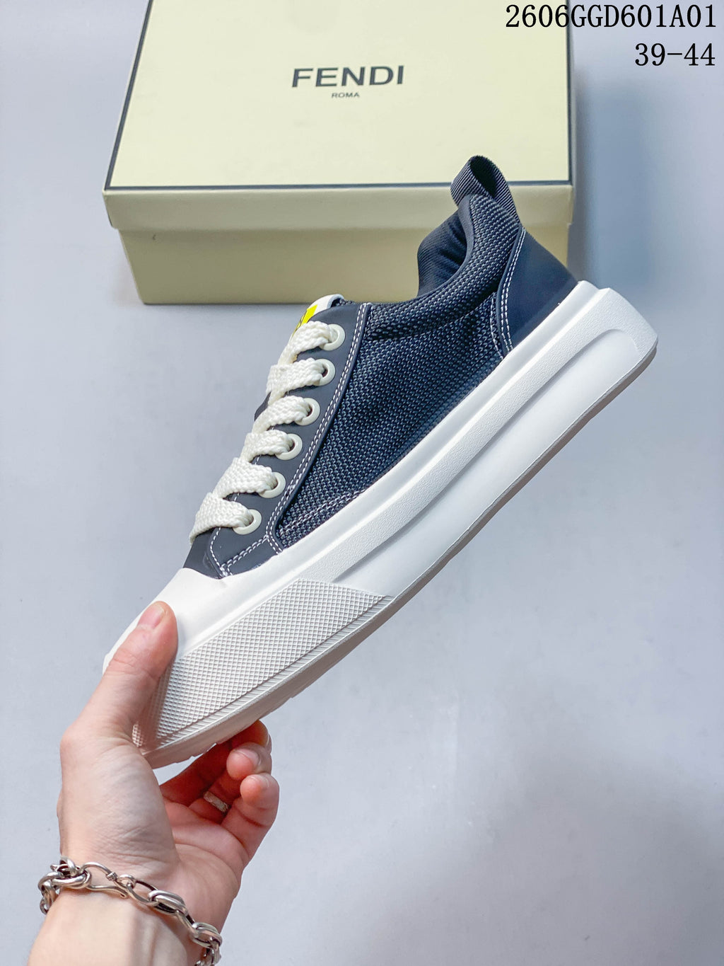Side profile highlighting the textured navy panels, white laces, and broad white sole.