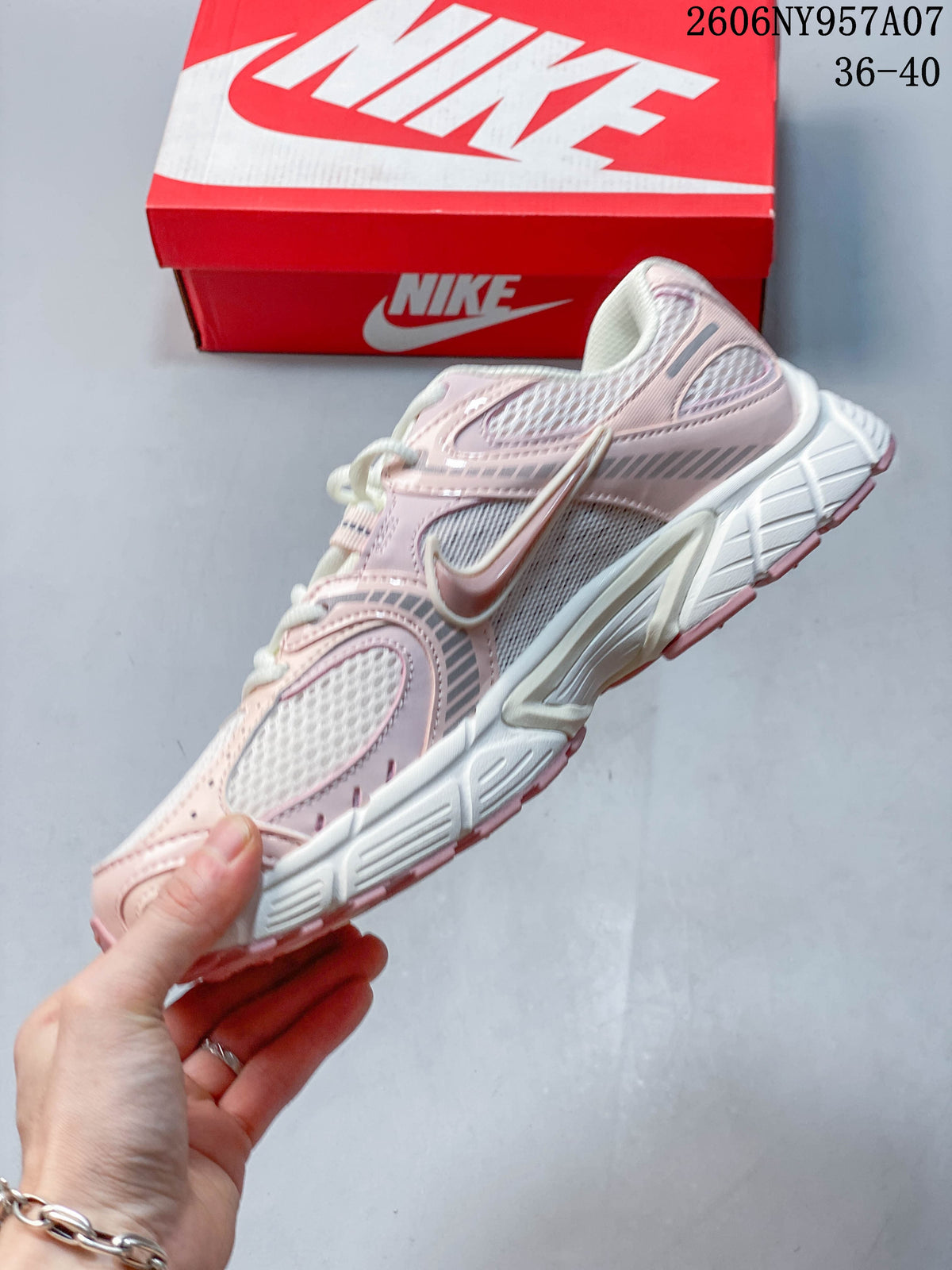 Side profile of a pale pink and white Nike V5 RNR sneaker with mesh panels and layered overlays