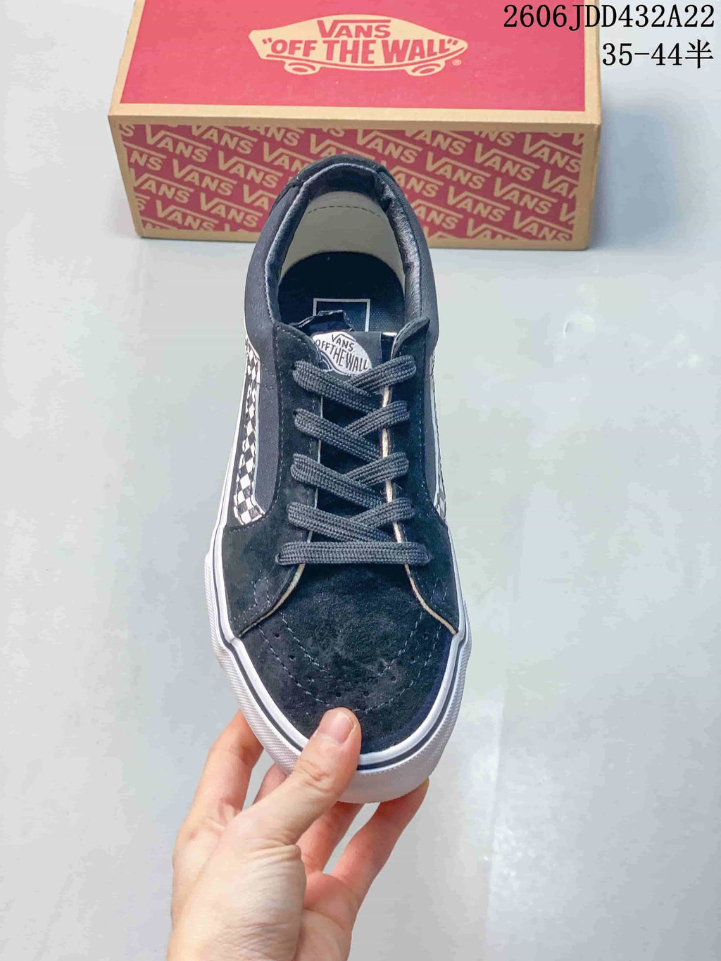 Front view of a black lace-up Vans low-top sneaker