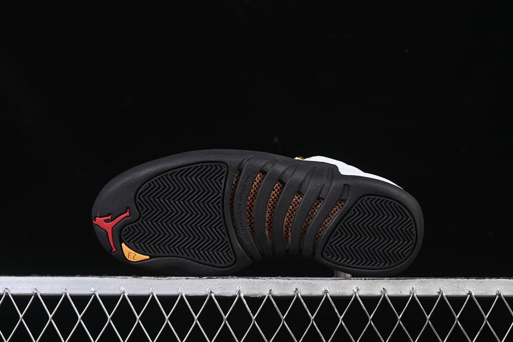 Outsole view showing black tread and red and yellow accents.