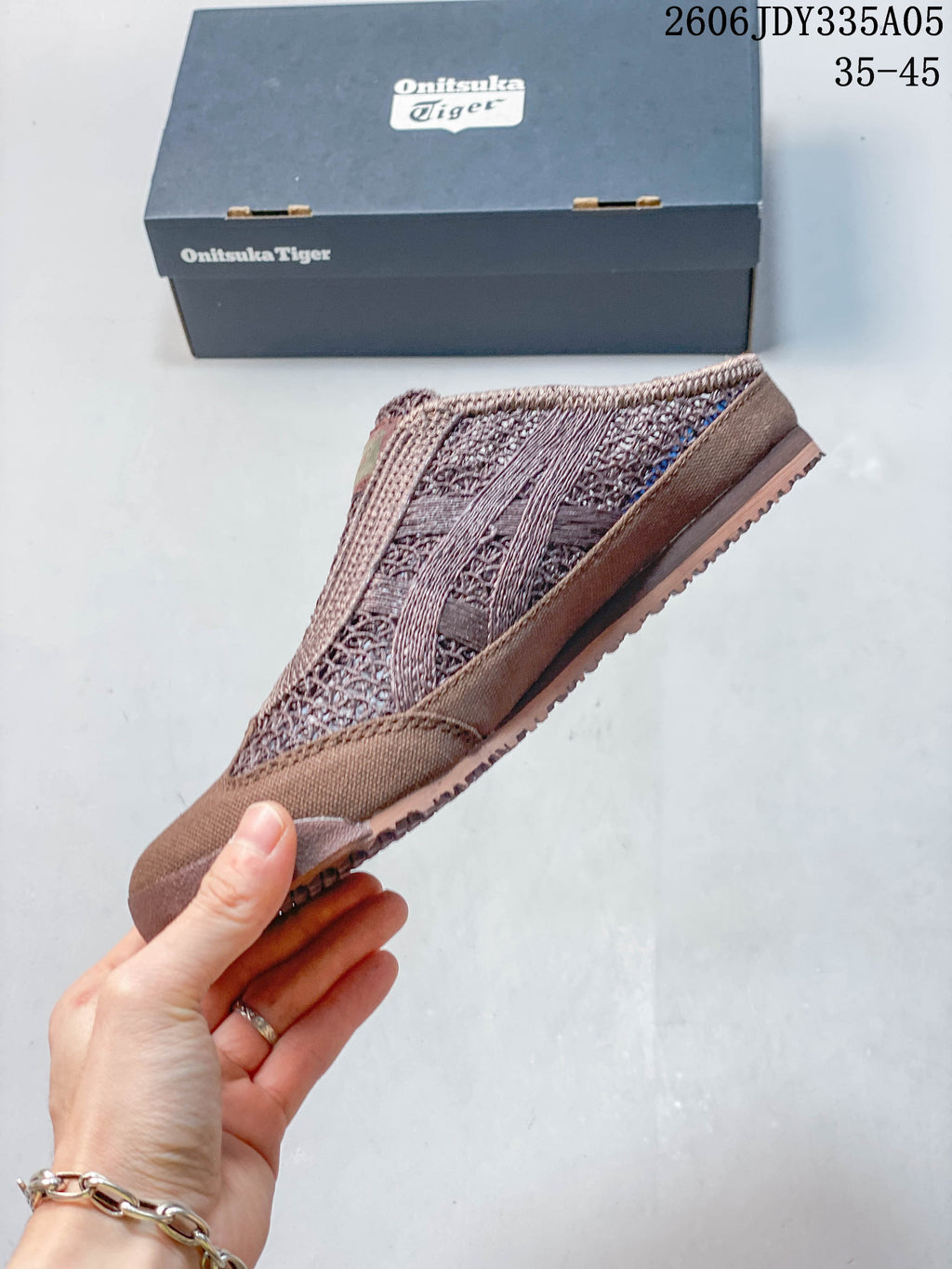 Side view of the brown Mexico 66 Sabot with openwork panels