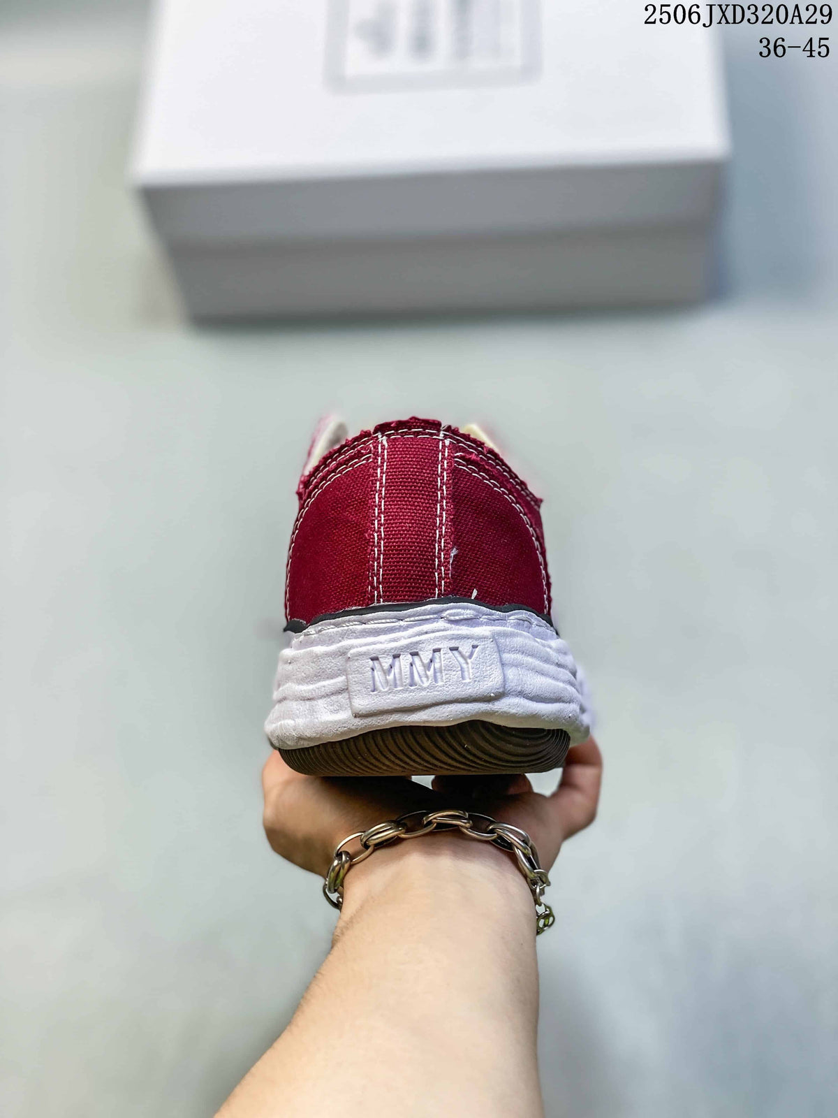 Rear view of a burgundy sneaker with an embossed MMY heel detail