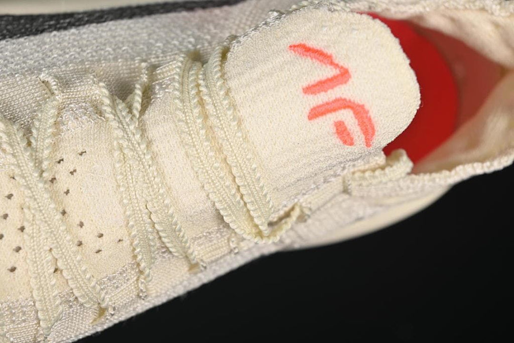 Close-up of the shoe tongue and cream-colored laces