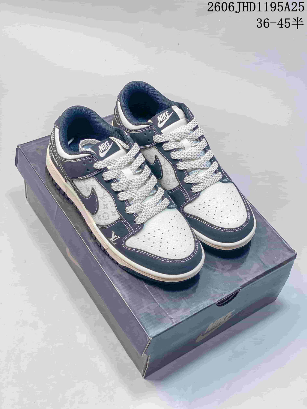 Pair of white and navy low-top sneakers with contrasting laces