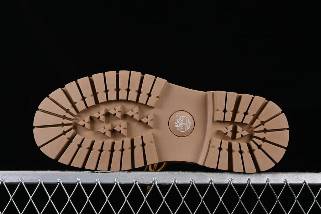 Underside view showing the boots' lug-pattern outsoles