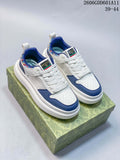 Pair of white and blue Gucci Screener GG sneakers with embroidered collar details, shown from the front.