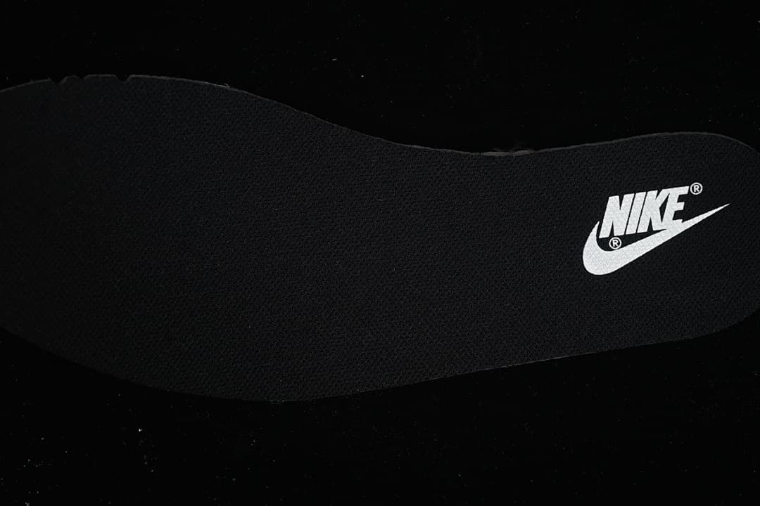 Close-up of a black insole with a visible Nike mark.