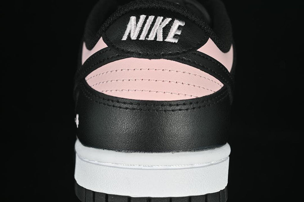 Rear close-up of the sneaker with pink heel panels and Nike branding