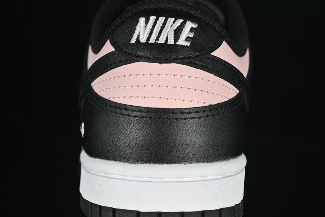 Rear close-up of the sneaker with pink heel panels and Nike branding