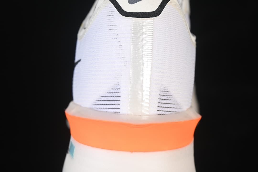 Rear view highlighting the white heel and orange midsole band