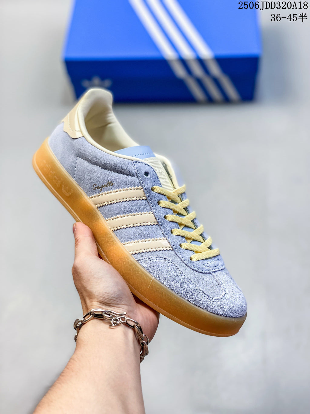Pale blue Adidas Gazelle low-top sneaker with cream stripes and laces