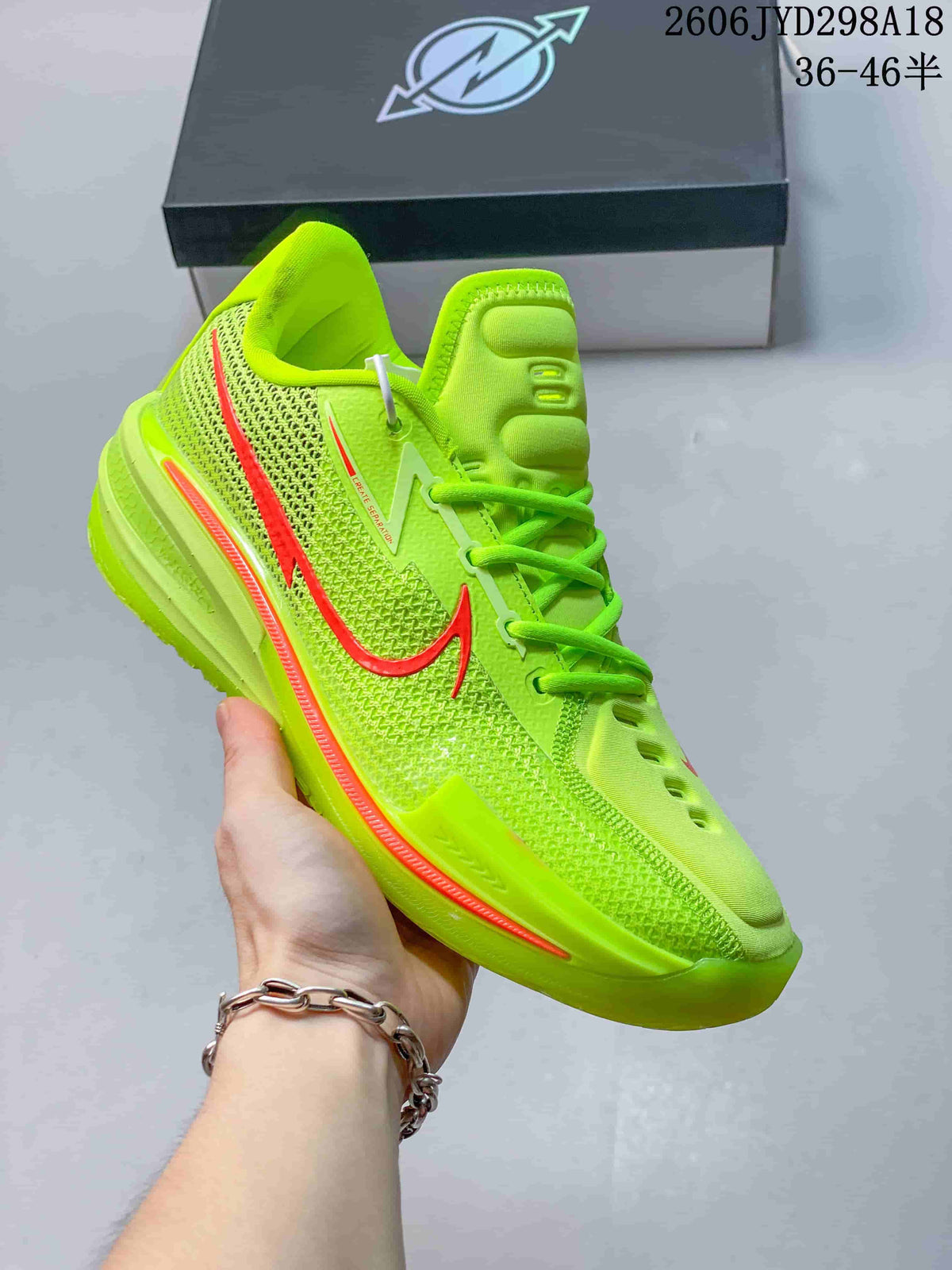 Bright neon green Nike Air Zoom GT Cut low-top shoe with coral accents.