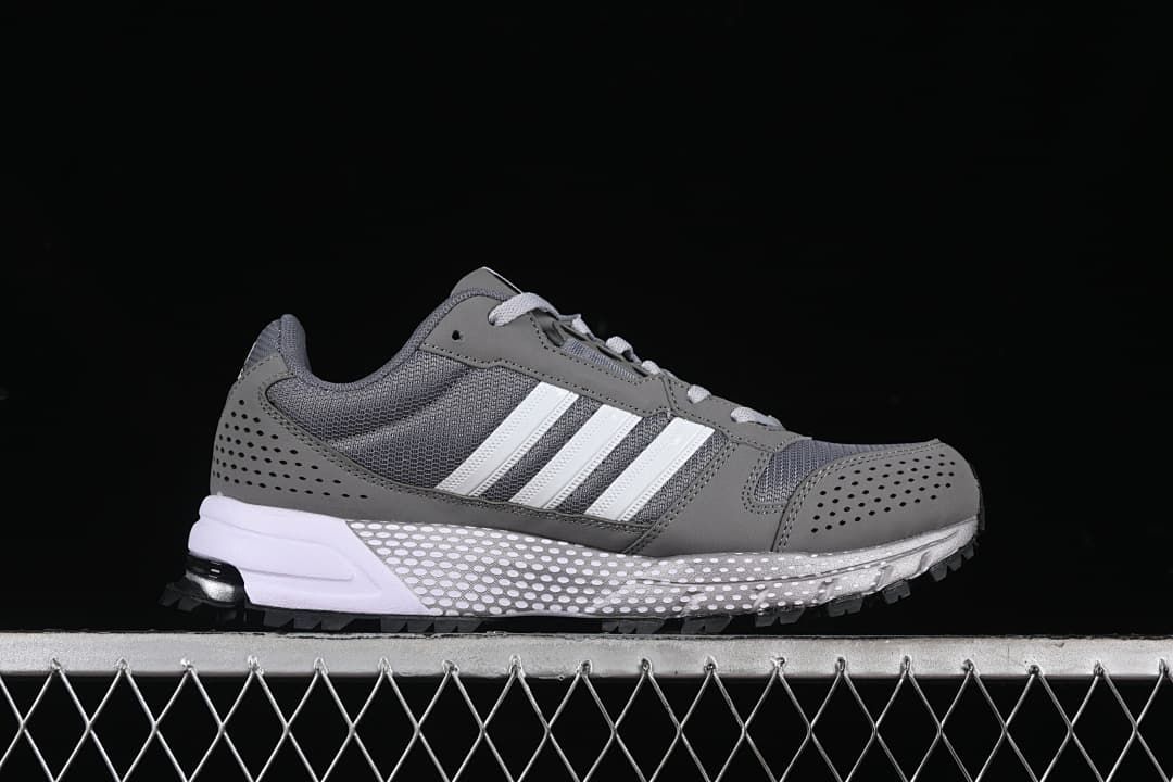 Side profile of the gray sneaker with white stripes and contrasting sole