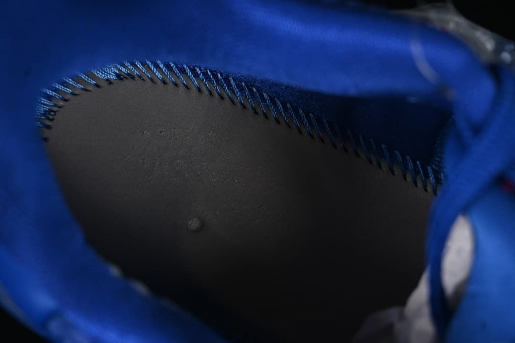 Close-up inside the blue shoe showing the dark lining and stitching