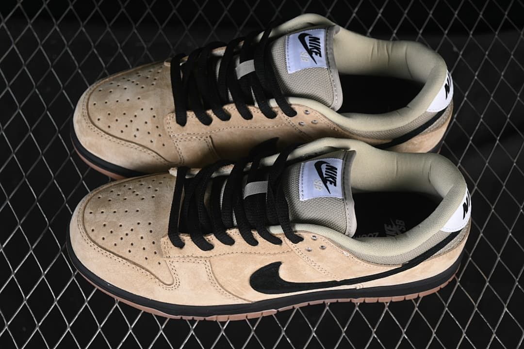 Top view of a pair of beige Nike SB Dunk Low sneakers with black laces