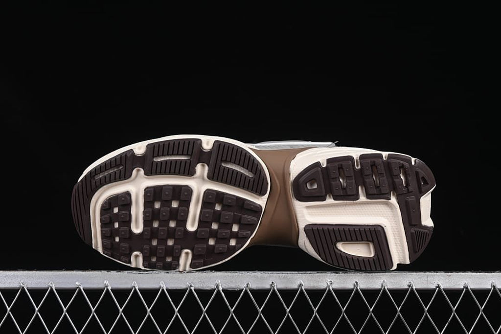 Underside view showing the patterned black and off-white outsoles