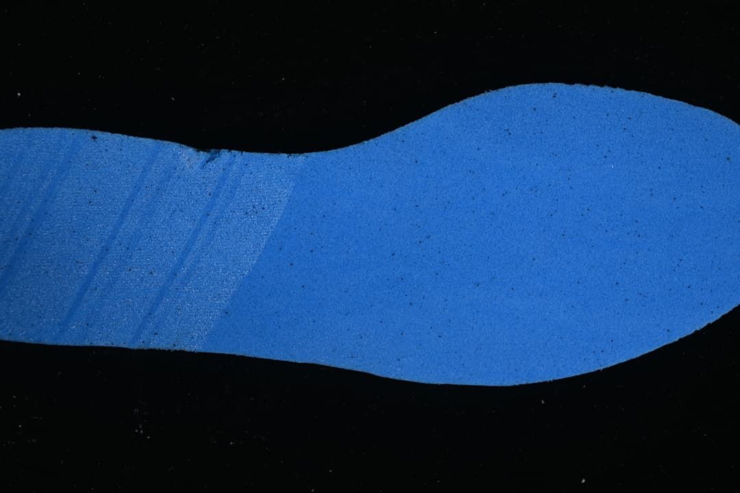 Blue shoe insert shown against a dark background