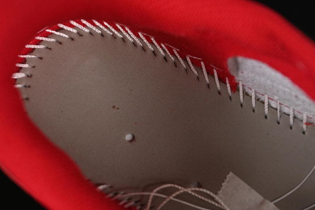 Close-up of stitching inside the red-lined shoe collar