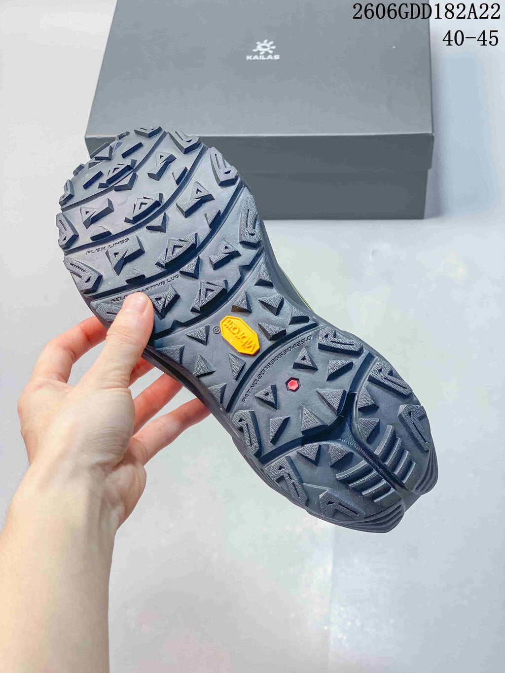 Close-up of the KAILAS shoe outsole with deep multidirectional lugs and Vibram branding