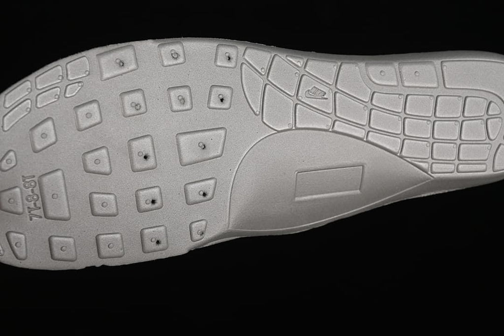 Close-up of the patterned outsole on a Nike Air Max 90 sneaker