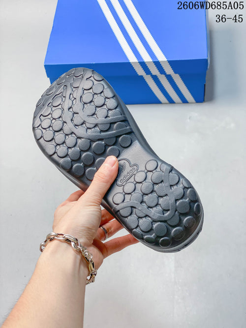 Textured outsole of the Adidas mule with a circular tread pattern