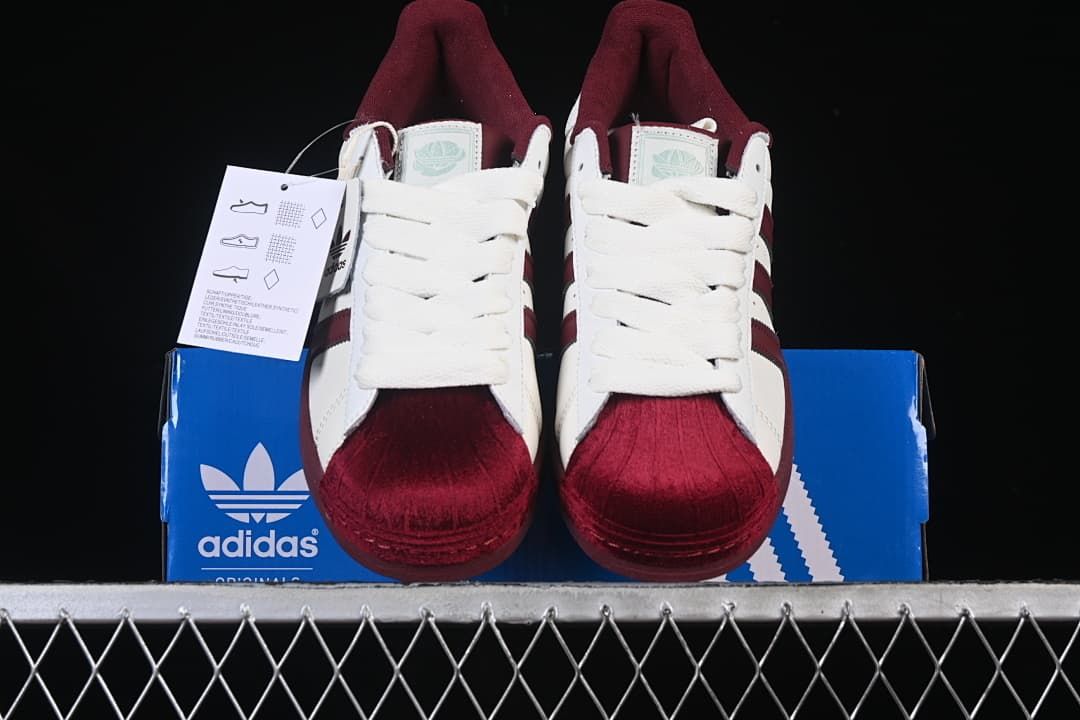 Front view of the pair showing burgundy shell-style toes and white laces.
