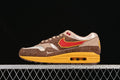 Side view of Nike Air Max 1 Big Head Origins sneakers in brown, cream, red, tan, and yellow.