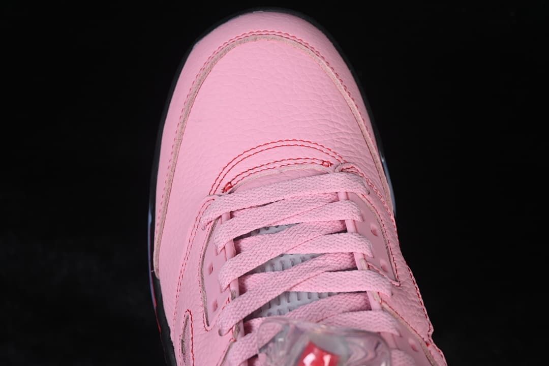 Top-down detail of the pink toe and lacing.