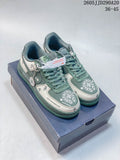 Pair of sage green and cream Nike Air Force 1 Shadow sneakers with decorative motifs and lace-up fronts